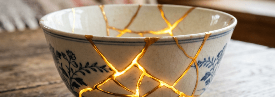 Ceramic bowl with visible golden repairs and glowing cracks