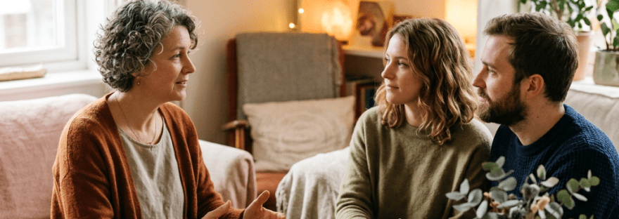 Couple meeting with a financial advisor at a living room table