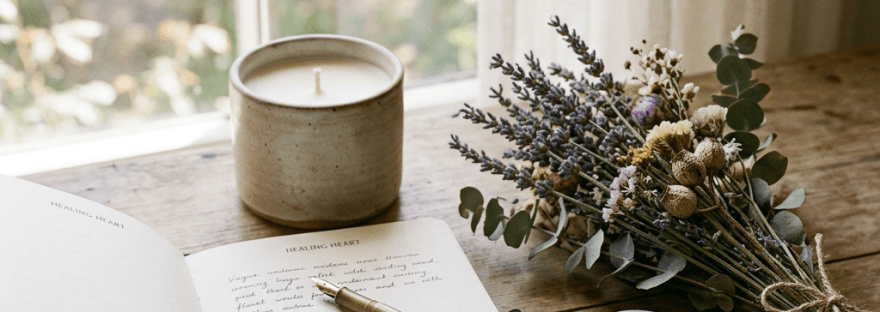 Open journal labeled HEALING HEART and REFLECTIONS beside stones marked HEALING and PEACE